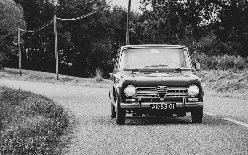 grayscale photo of car on road