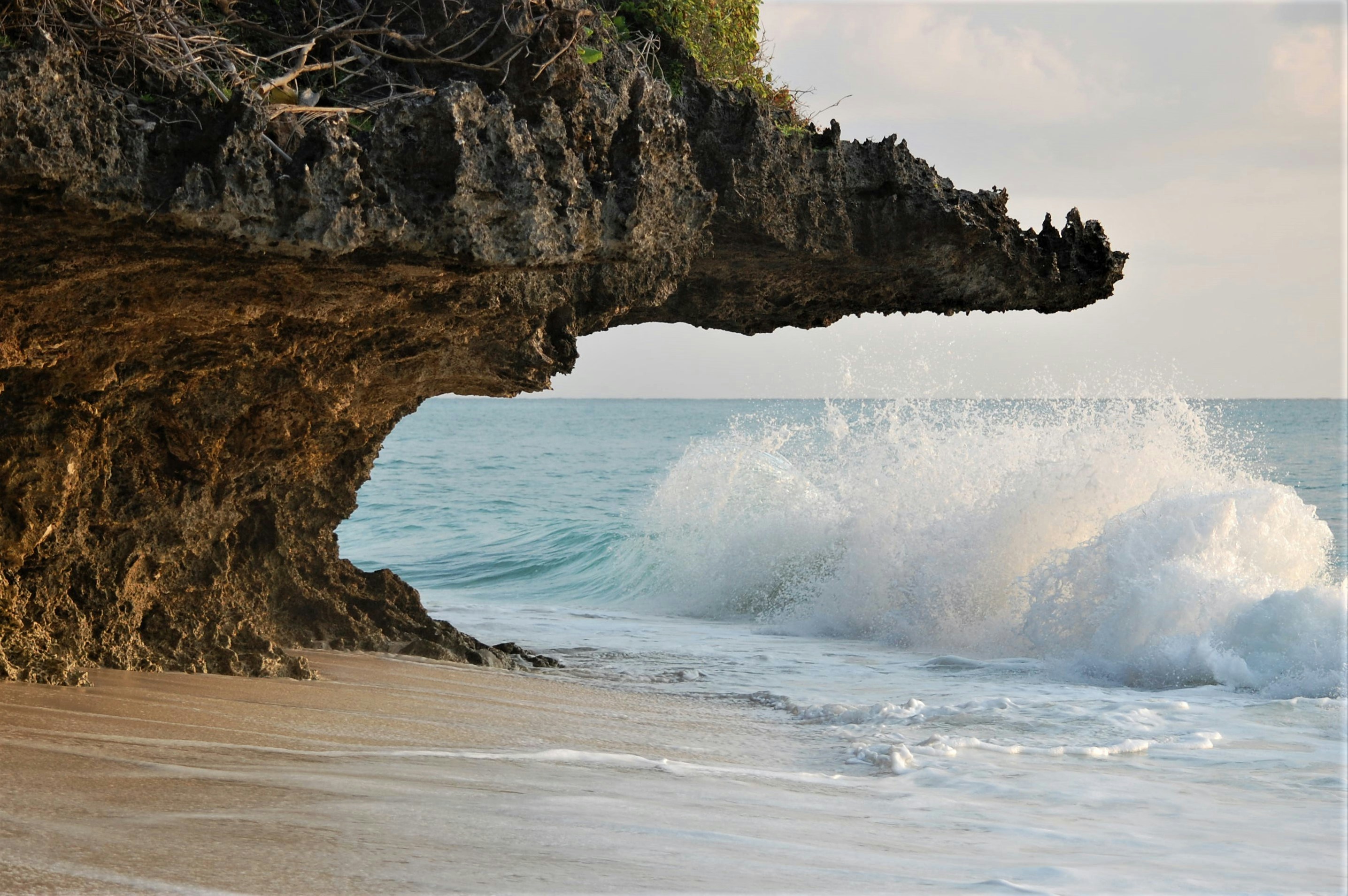 brown rock formation on sea during daytime