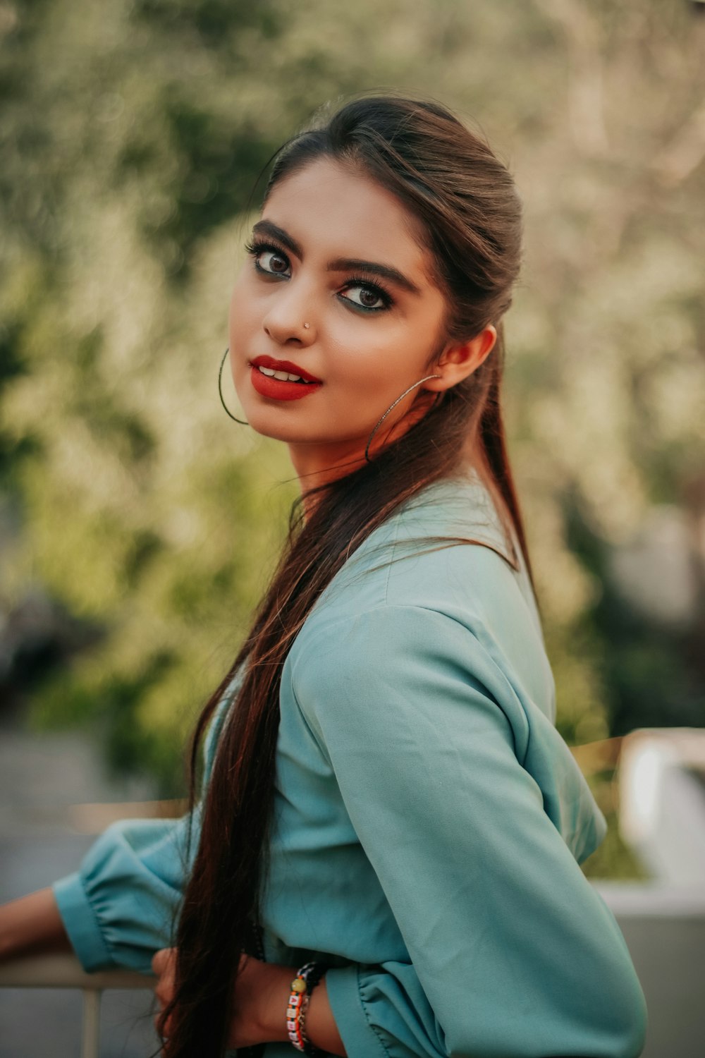 woman in teal long sleeve shirt