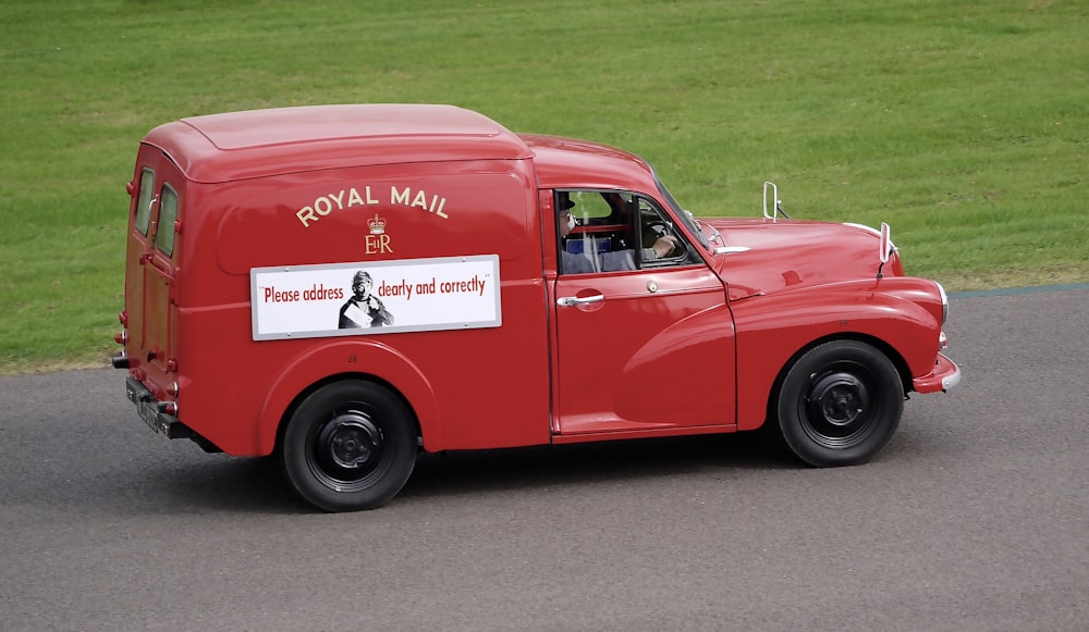 red vintage car on road during daytime