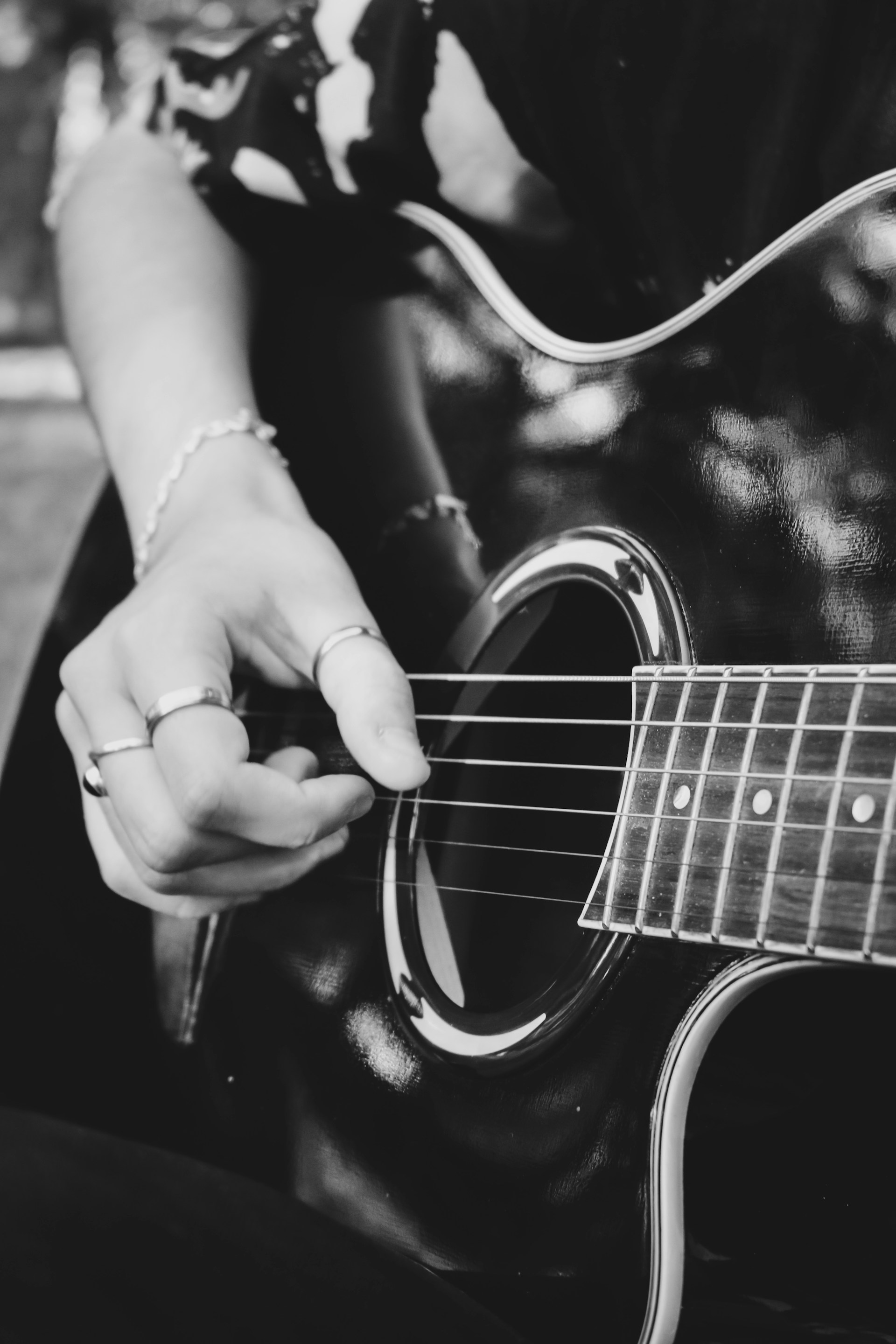 Close-up of Leandro’s hands skillfully playing an acoustic guitar, capturing the texture of the strings.