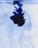 Dark blue ink swirls and diffuses in clear water, creating intricate patterns and shapes against a light background.