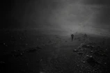 Still from a moody black-and-white short film featuring a lone figure walking through fog.