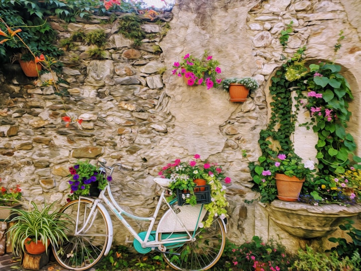 A cozy French countryside scene with a vintage bicycle leaning against a stone wall adorned with lavender.