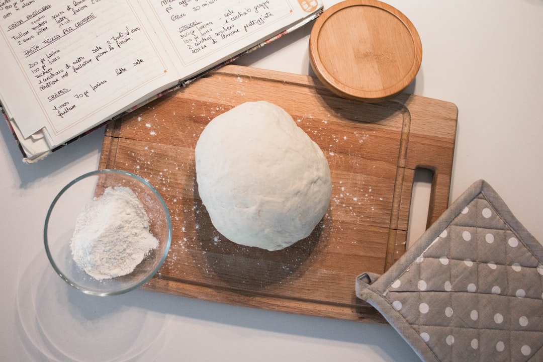 white dough on brown wooden chopping board