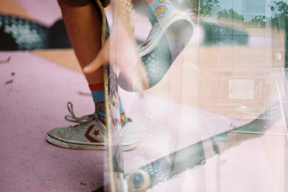 person holding white and black flip flops