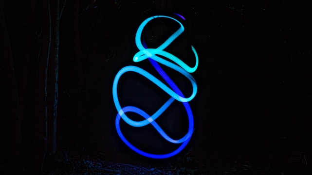 A sleek dark blue and black background with vibrant purple and cyan accents forming a modern tech-inspired abstract design.