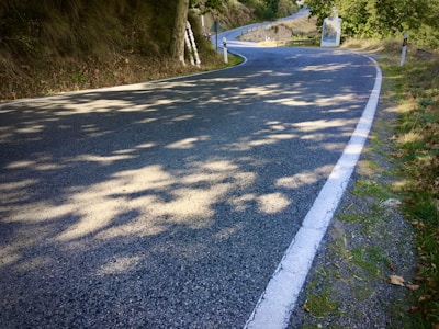A freshly paved road stretching through a rural landscape, highlighting smooth asphalt and clear markings.