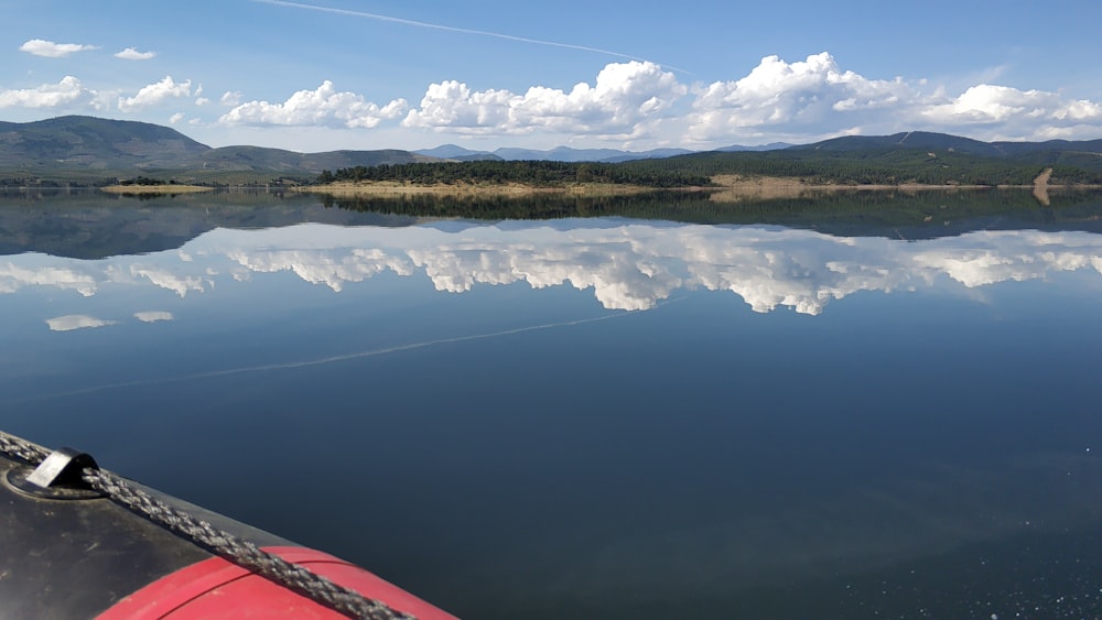 body of water near green trees under blue sky during daytime