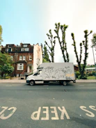 Modern delivery van with Trustpath branding parked outside a hospital