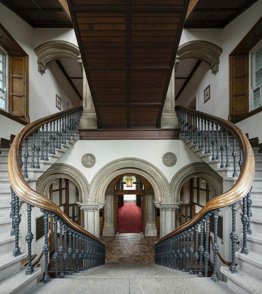 brown wooden staircase with red carpet