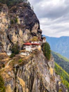 white and red concrete building on top of mountain during daytime