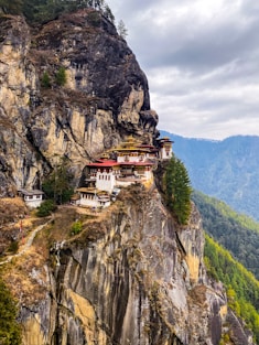 white and red concrete building on top of mountain during daytime