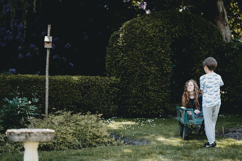 woman in blue dress sitting on green plastic crate