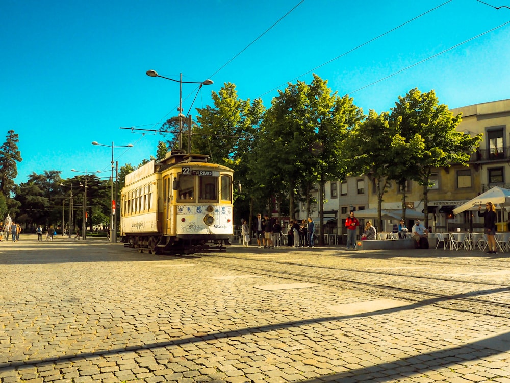 yellow and white tram on road during daytime