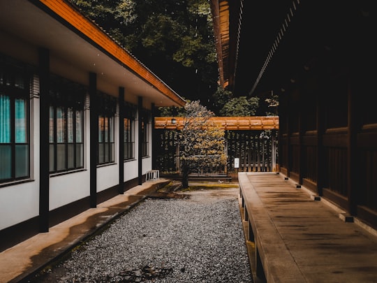brown wooden bench near brown wooden house in Meiji Shrine Japan