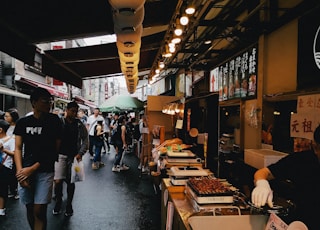 people standing in front of food stall