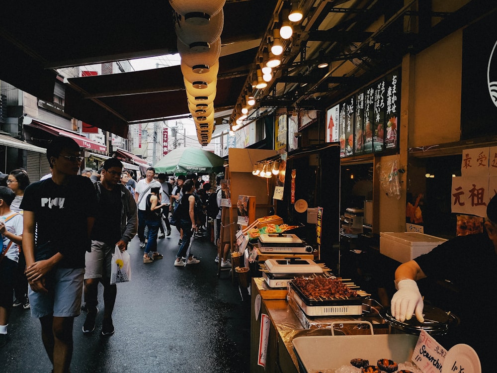 people standing in front of food stall