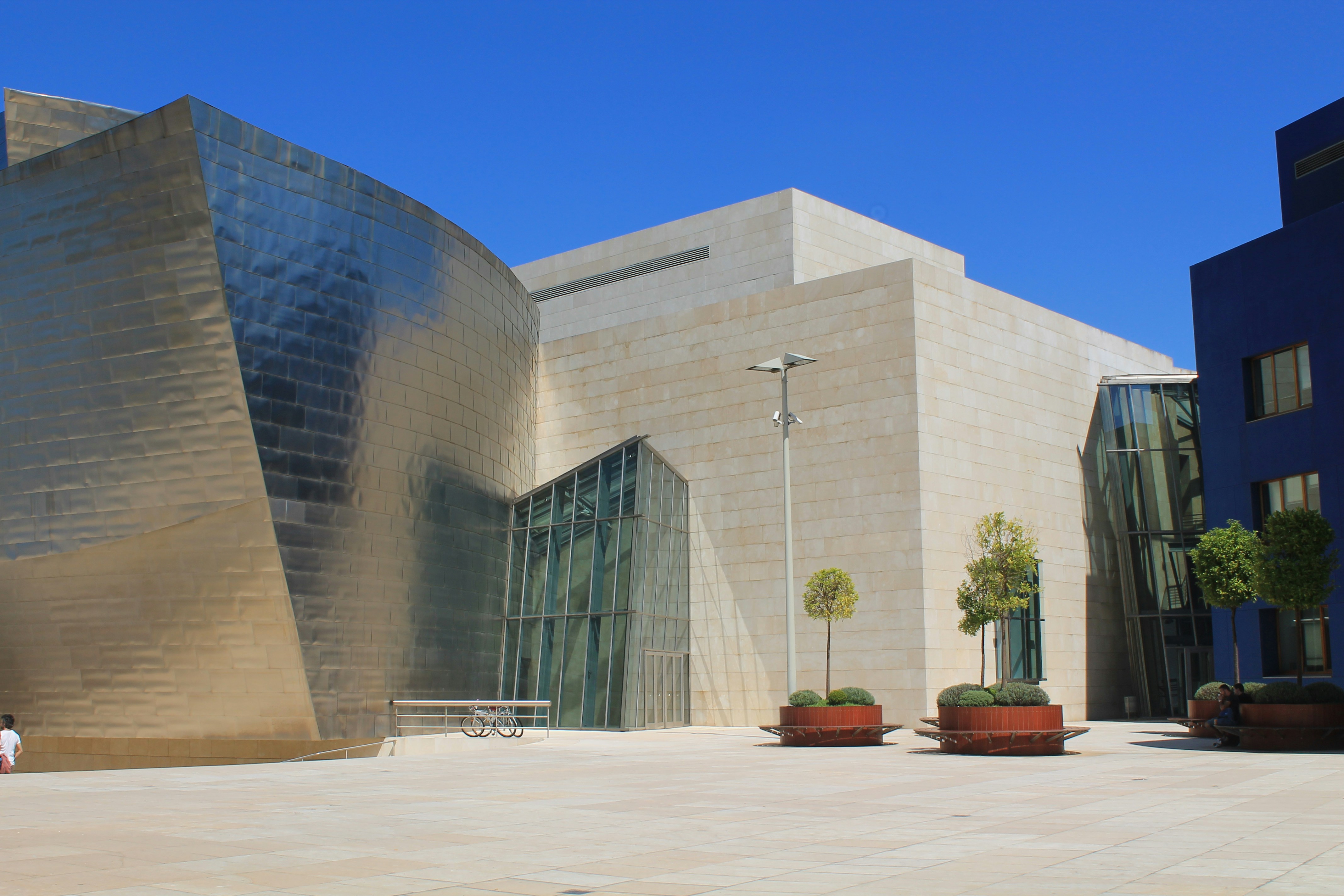 gray concrete building near green trees during daytime