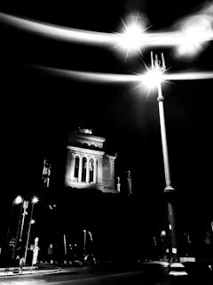 Dramatic nighttime scene with LED spotlights accenting the facade of a landmark monument.