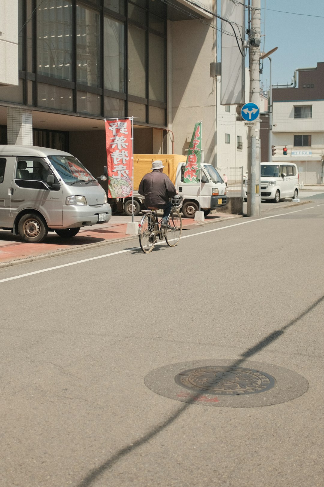 man riding on bicycle on road during daytime