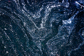 A minimalist deep navy background with fine-line golden constellations forming a subtle celestial pattern.