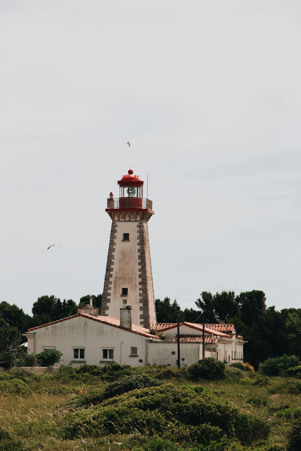 bâtiment en béton blanc et rouge sous le ciel blanc pendant la journée