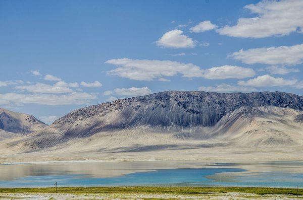Brown and white mountain under blue sky during daytime — Pamir Highway, Tajikistan
