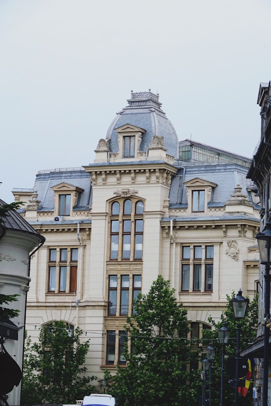beige concrete building during daytime in Bucharest Romania