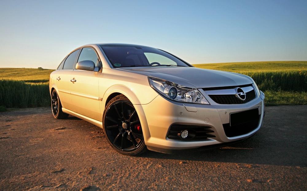 yellow mercedes benz coupe on brown sand during daytime