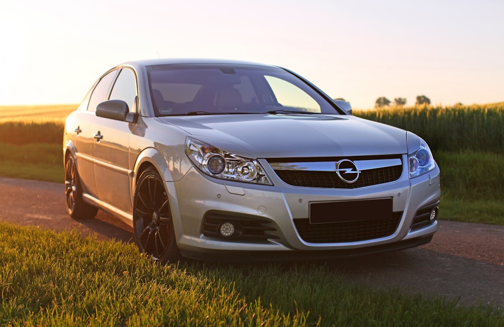 silver mercedes benz c class on green grass field during daytime