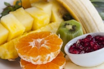 sliced orange fruit on white ceramic bowl