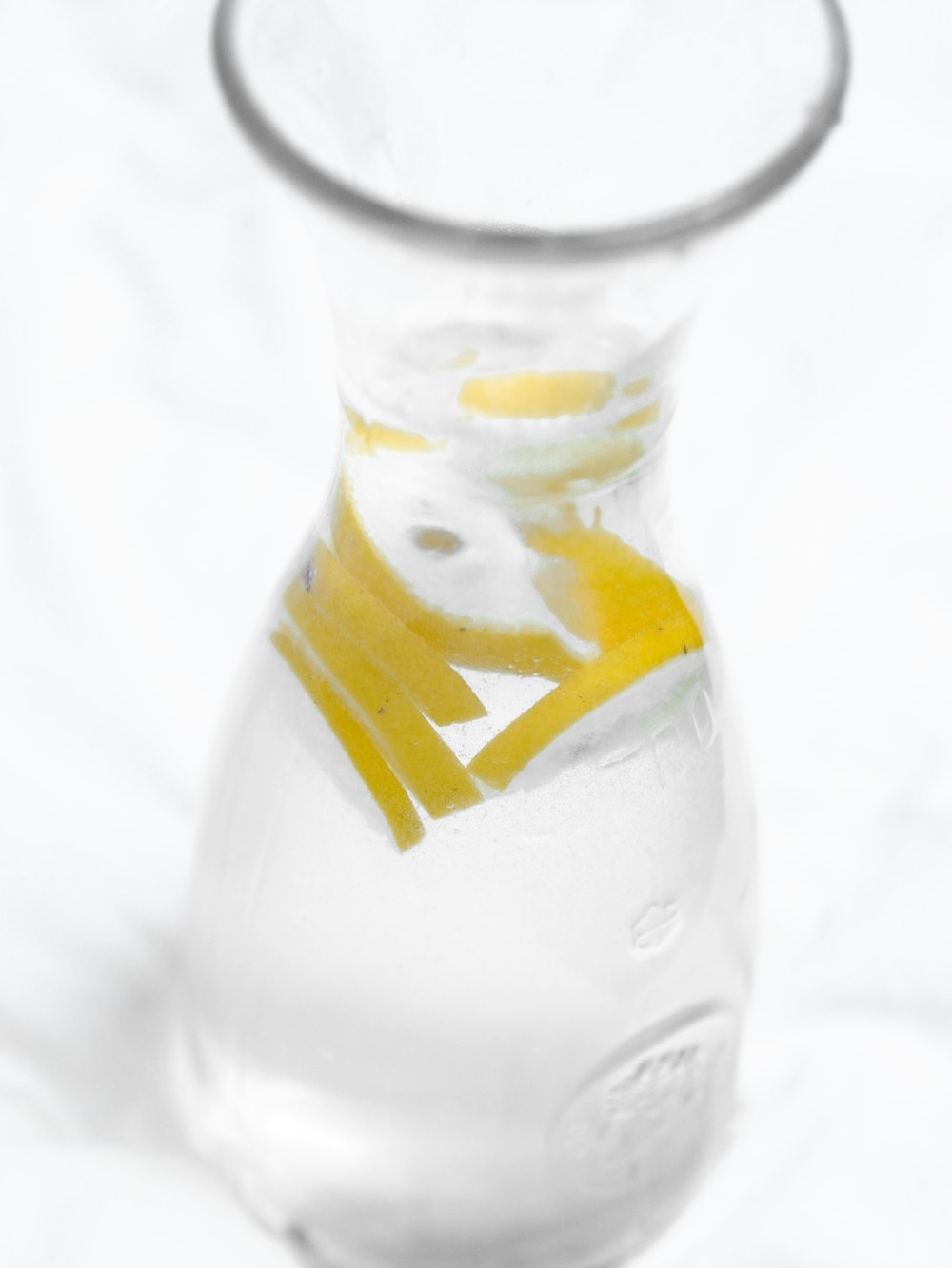 clear glass bottle with yellow and white label