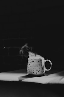 Close-up of a whimsical mug with a witty quote, held by a smiling mom