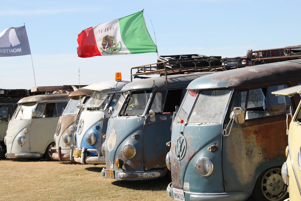 white volkswagen t-2 van with red and white flag on top