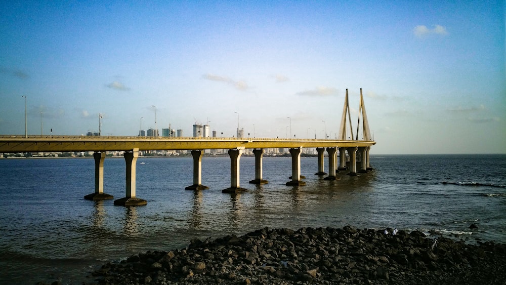 white concrete bridge over the sea during daytime
