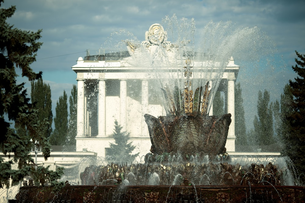 water fountain in front of white building