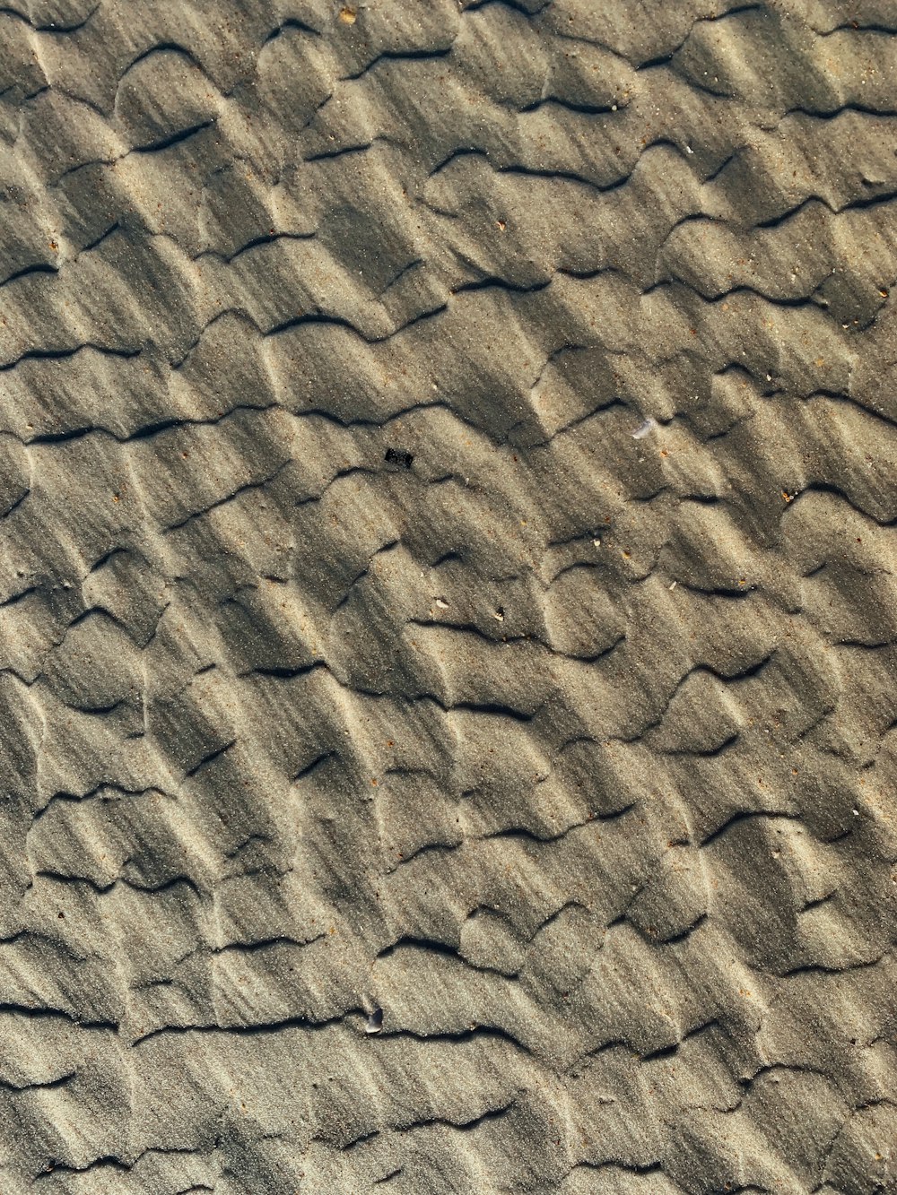 brown and black sand during daytime