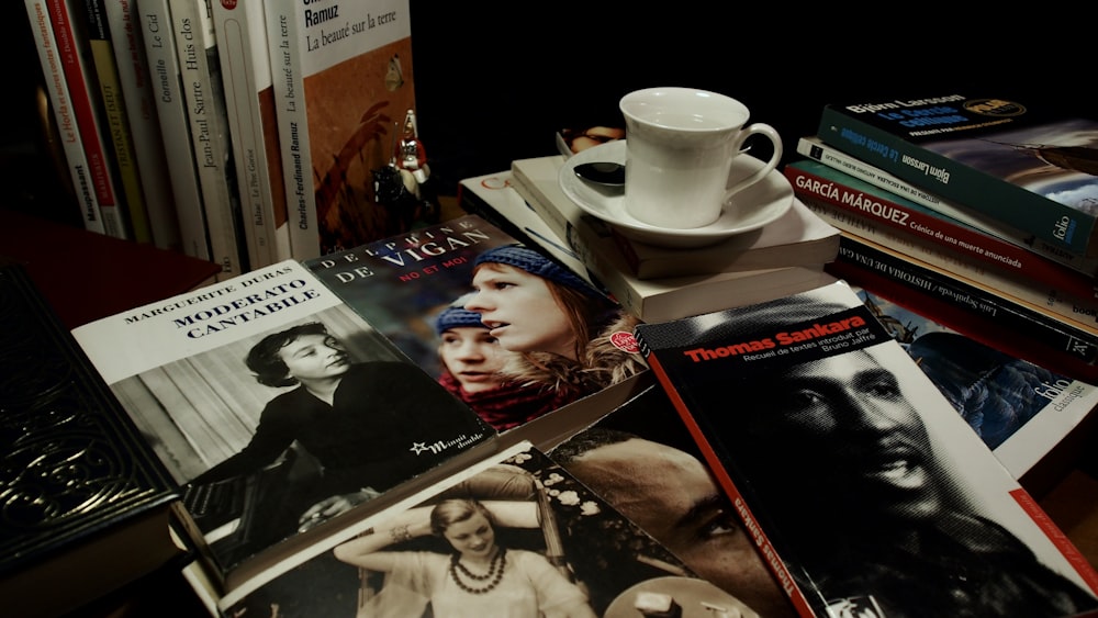 a table topped with books and a cup of coffee