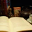 A cozy corner with a vintage astrology book open next to a steaming cup of tea on a wooden table.