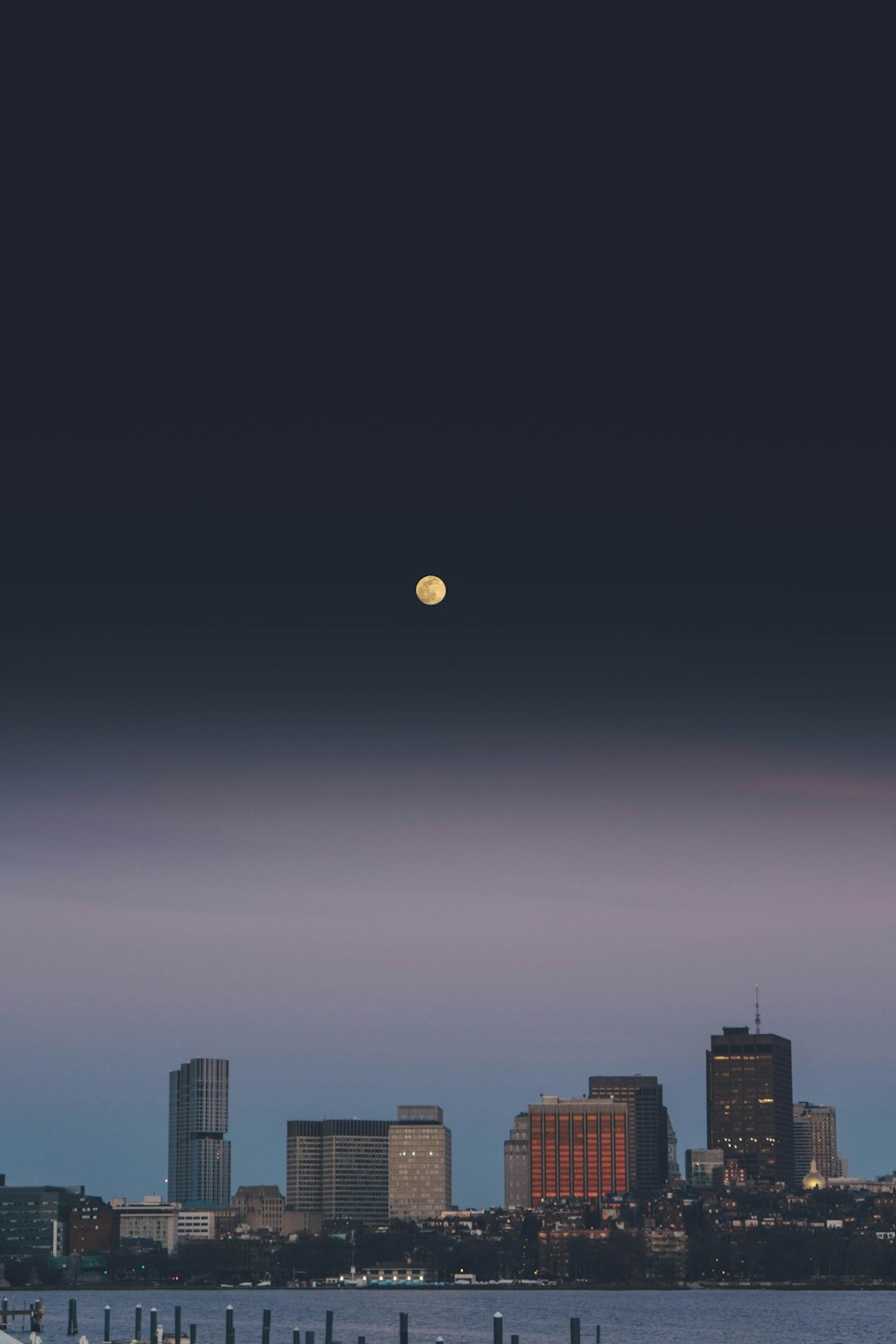 full moon over city buildings