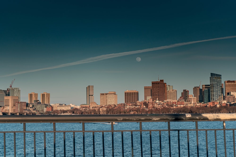 city skyline across body of water during night time