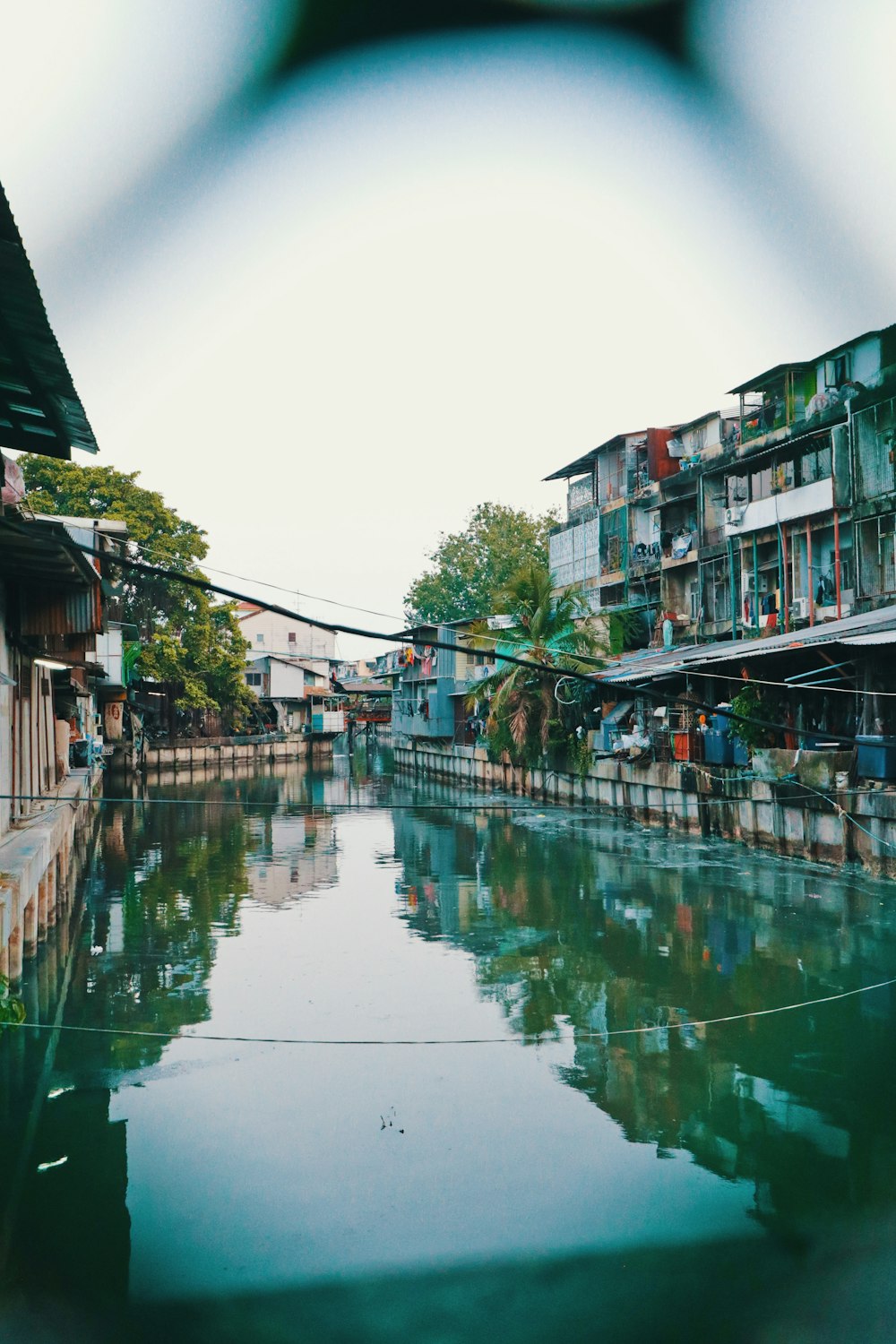 body of water between buildings during daytime