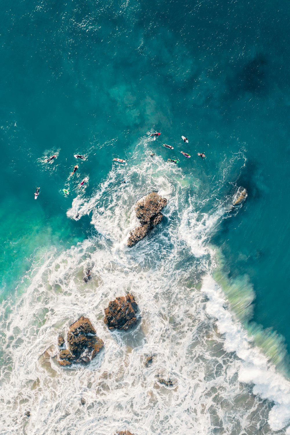 brown rock formation on body of water during daytime