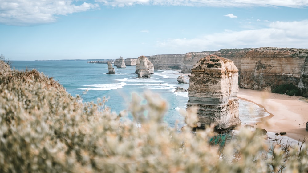 brown rock formation on blue sea under blue sky during daytime