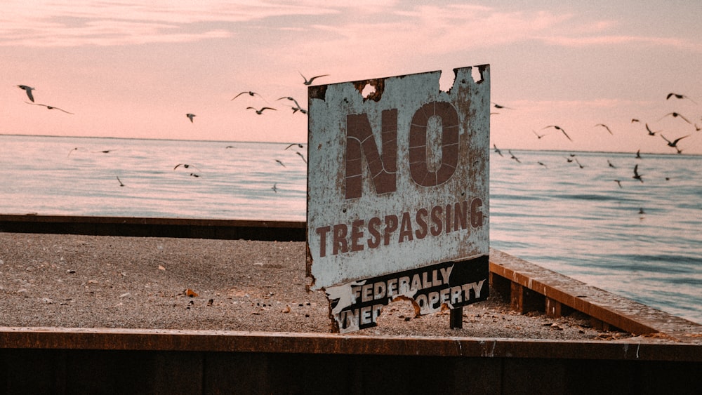 white and blue wooden beach signage