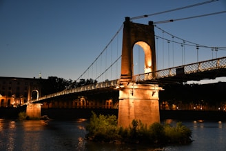 brown bridge over river during night time