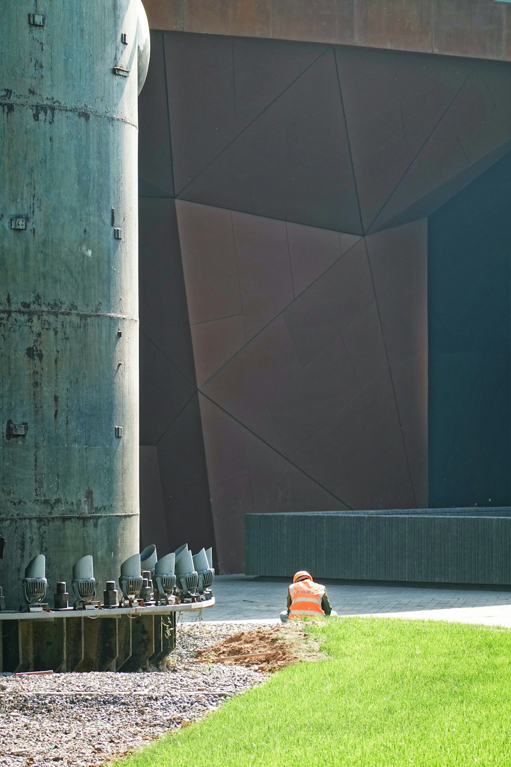 people sitting on white chairs near gray concrete wall during daytime