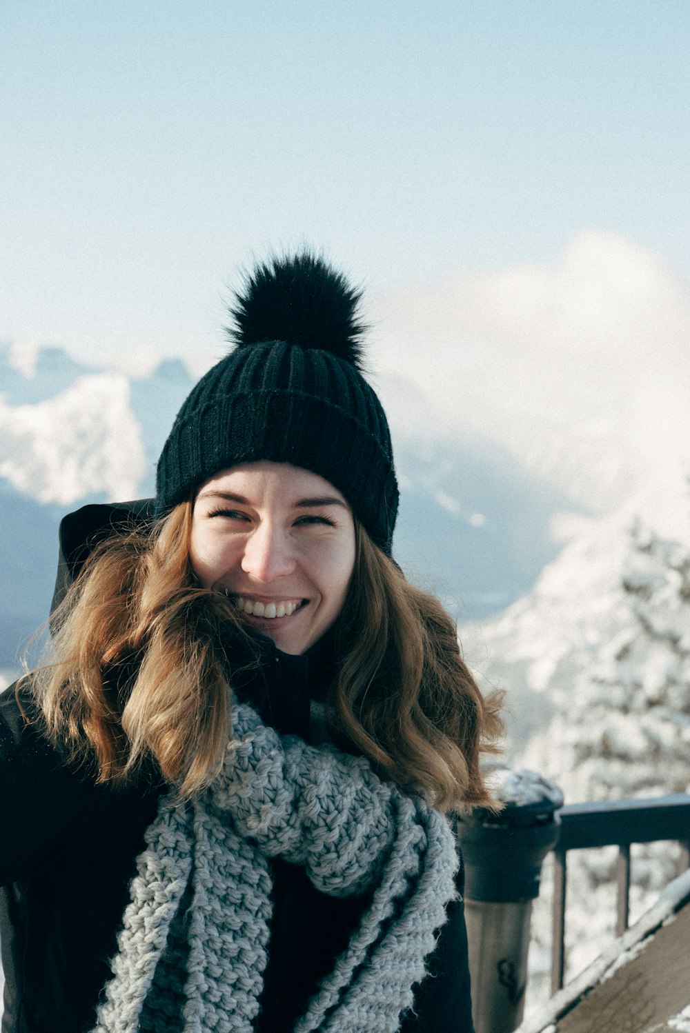 woman in black knit cap and white and black knit scarf