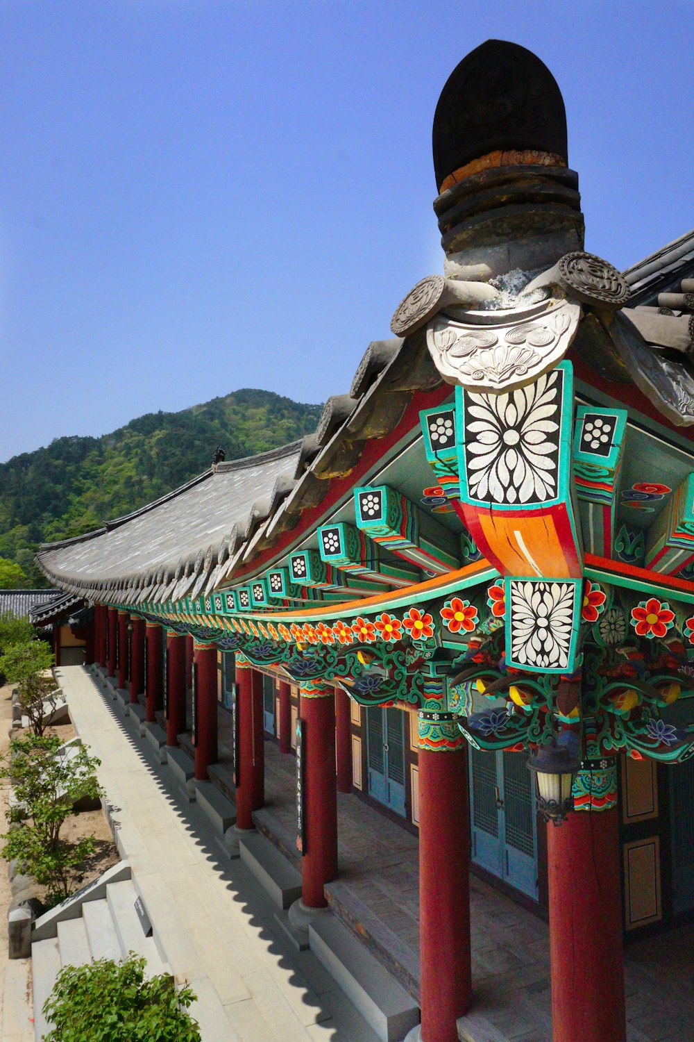 green and brown temple near green mountain under blue sky during daytime